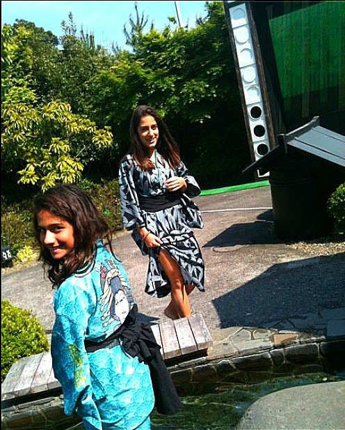 Junior Meera Singh (age 13 in photo), wears a black and white Kimono while wading in the Odaiba hot spring theme park  with sister freshman Dhara Singh (age 11 in photo) in Japan. “Japanese people were more orderly; they were more polite and cared a lot about rules,” Meera Singh said.