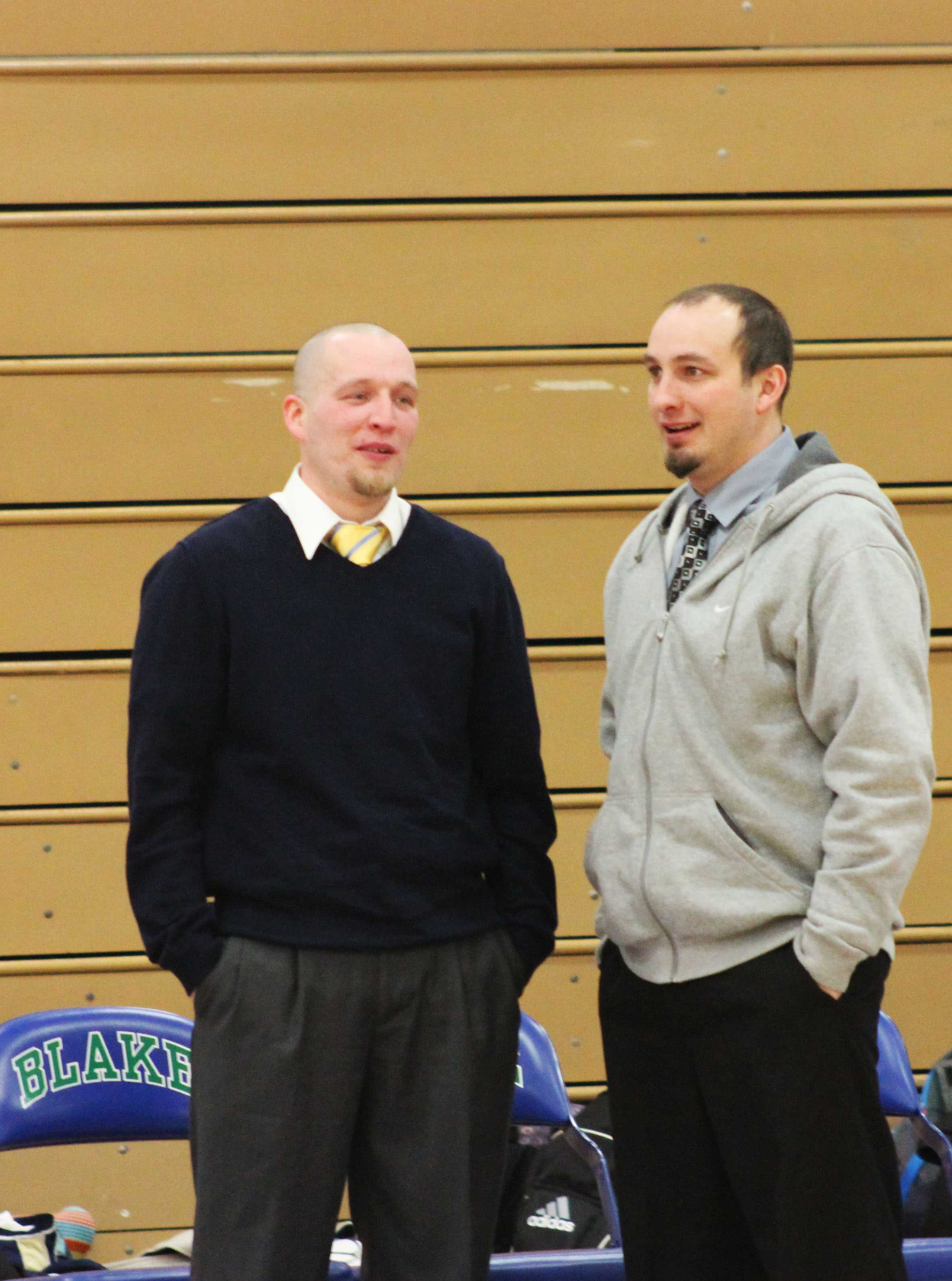Leigh and Rick Hemric discuss strategy before a game against the Blake School on Jan. 25.  “I would say we have a very similar coaching style. Off the court he has strengths where I have weaknesses and vice versa,” Rick Hemric said.