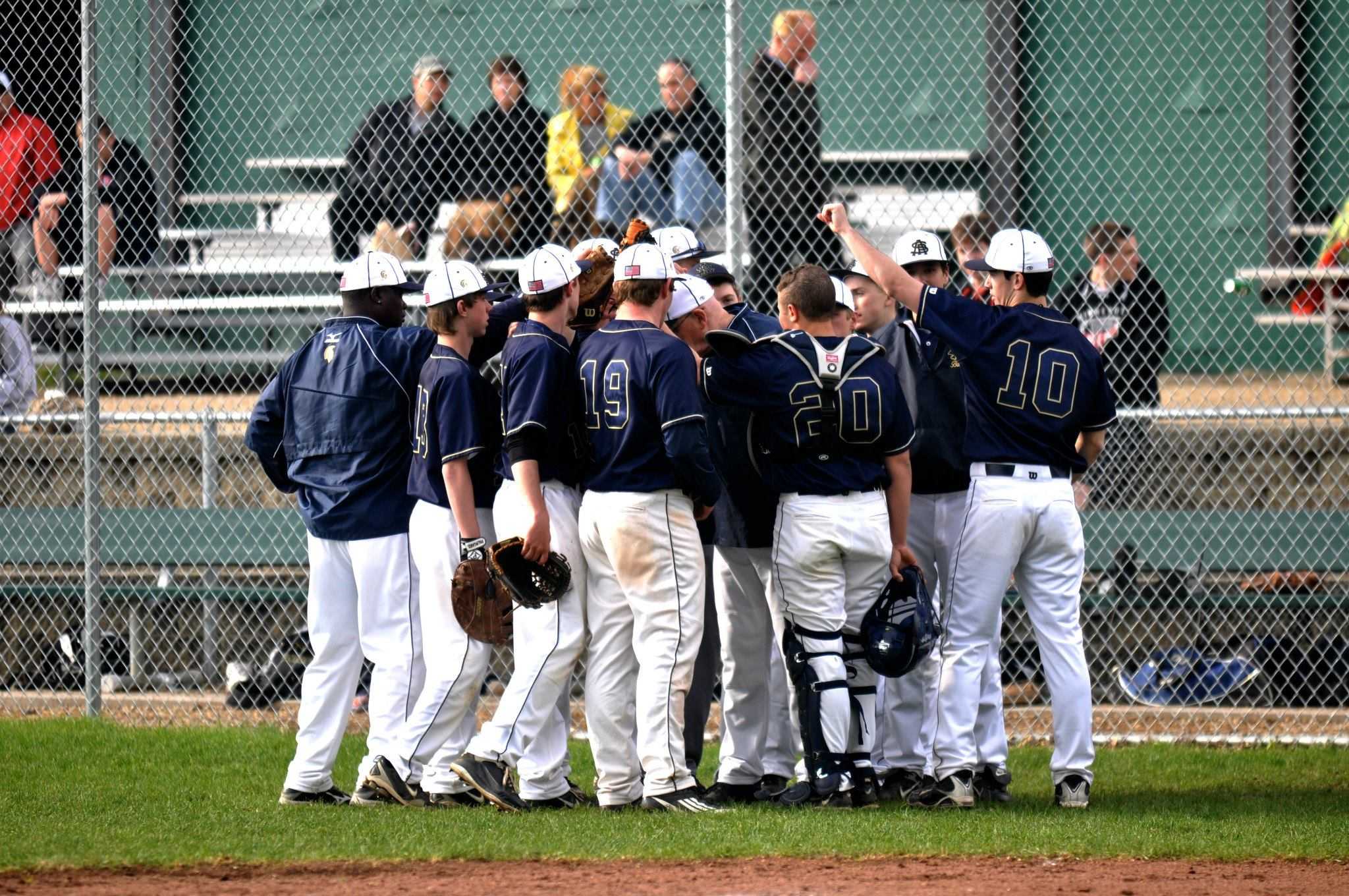 The Boys Varsity Baseball huddle together during the 2011-2012 season. This year, the snow has delayed their season, forcing them to postpone all of their games so far. 