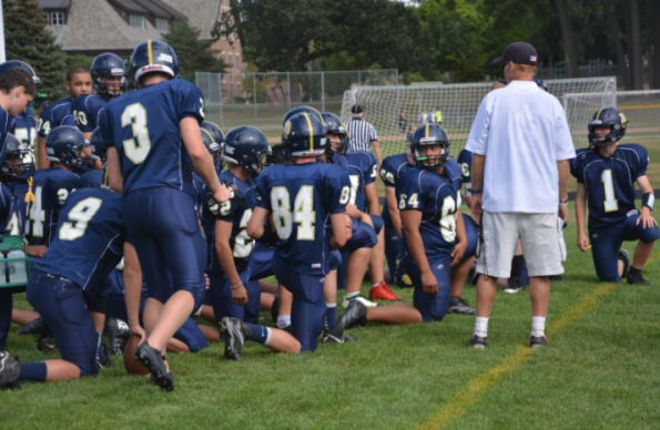 The Boys Varsity Football team prepares to play a game against St. Agnes High School on Sept. 12. The team lost 6-40. We love big crowds and we love them more when we can hear them,” Senior captain and  offensive lineman Sam Carlson said. 