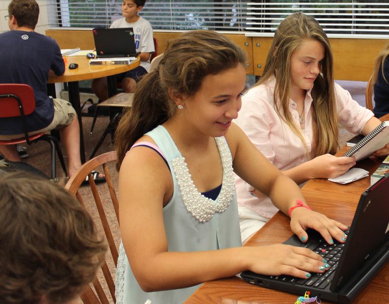 From left to right, freshmen Maria Perkkio and Lauren Hansen work on homework during 3rd Period study hall in the upper library. “So far the feedback has been very positive. The proctors like the atmosphere,” Dean of Students Judy Cummins said.