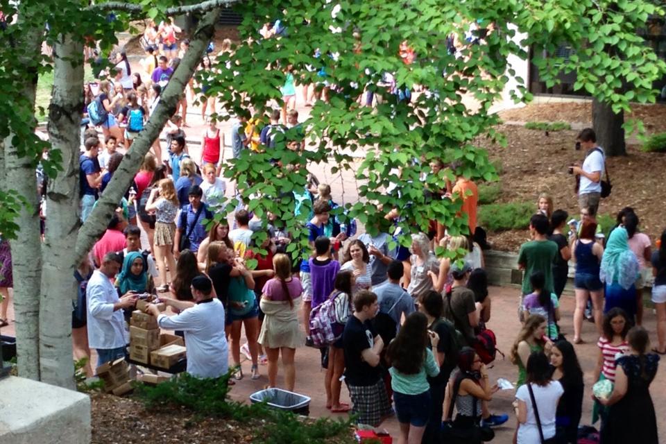 Students and teachers socialize with ice cream and popsicles in the Lilly Courtyard after the first day of school.