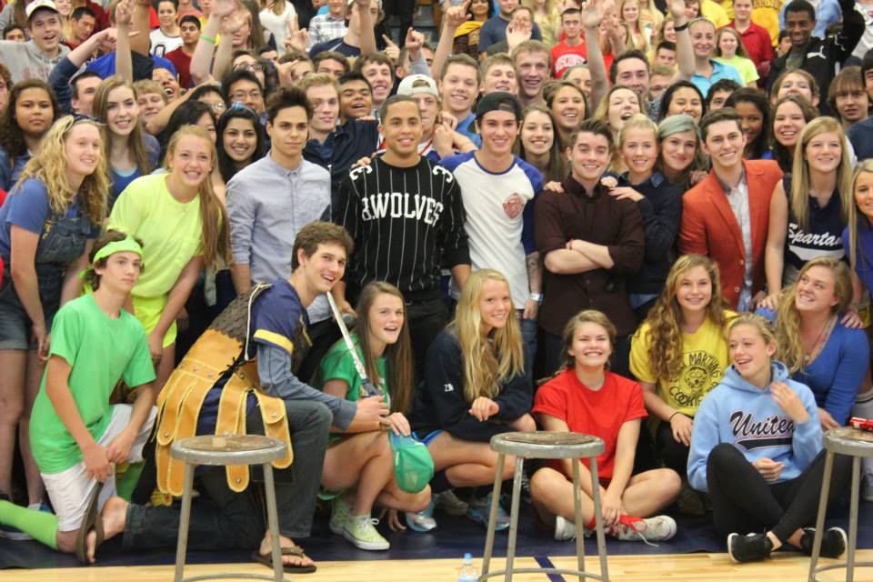 Students pose for a group photo with boy band Midnight Red. 