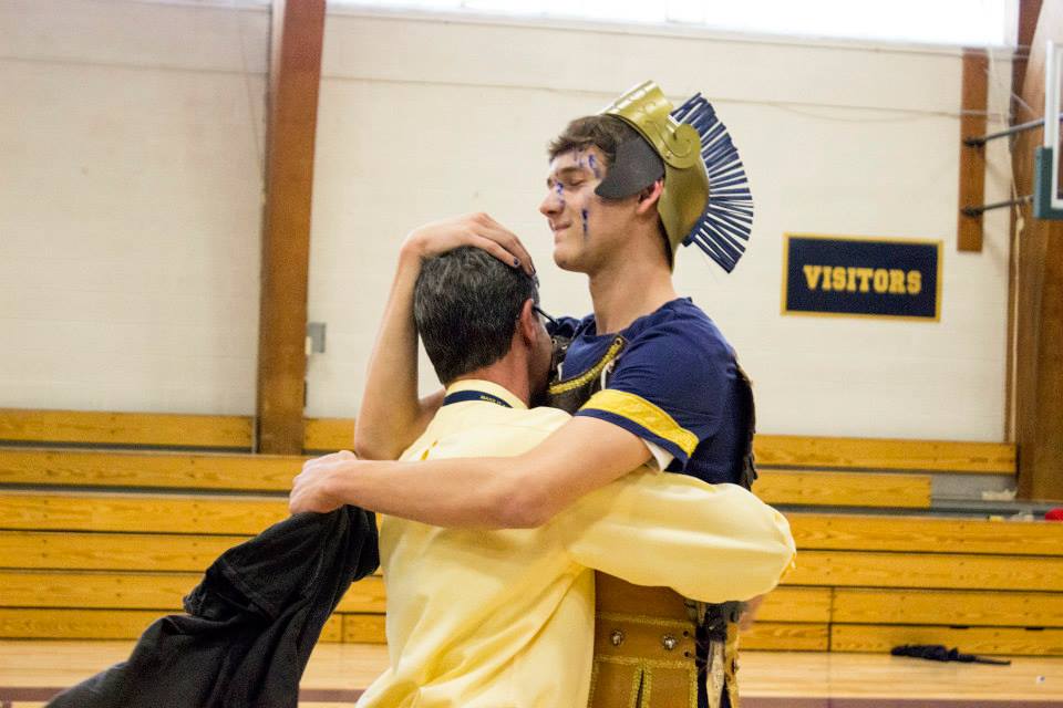 The Spartan senior Connor Allen gives Upper School Spanish teacher Rolando Castellanos a hug.
