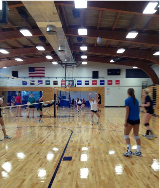 The Girls Varsity Volleyball team practices on the new gym floor.  The gym is now more open to students during school hours. “Being a basketball player, it’s nice to get a couple shots up during the day, especially when I have a couple minutes here and there open in my schedule,” sophomore Kent Hanson said.