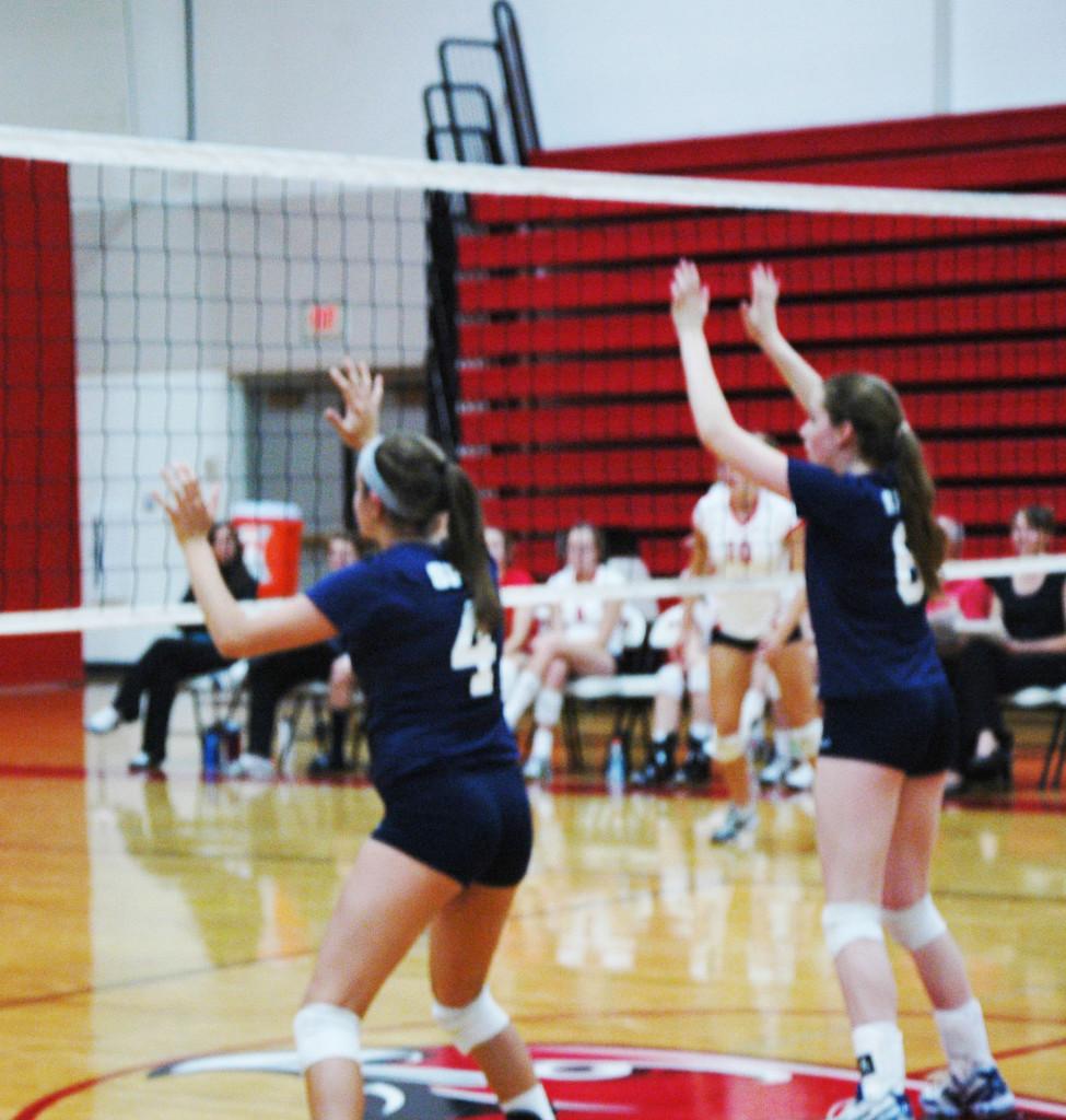 From left: Junior captain and outside hitter Mira Grinsfelder and senior captain and middle hitter Claire Foussard are in the ready stance in a match against Minnehaha Academy on  Sept. 16. “I think this season will be a huge improvement over seasons before,” Grinsfelder said.