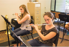 Senior Claire Foussard and sophomore Maya Smith  play flutes in a winds sectional class. “I don’t really like how we have to do more stuff during tutorial, but I don’t think it’s that bad,”  senior Alex Miller said. 