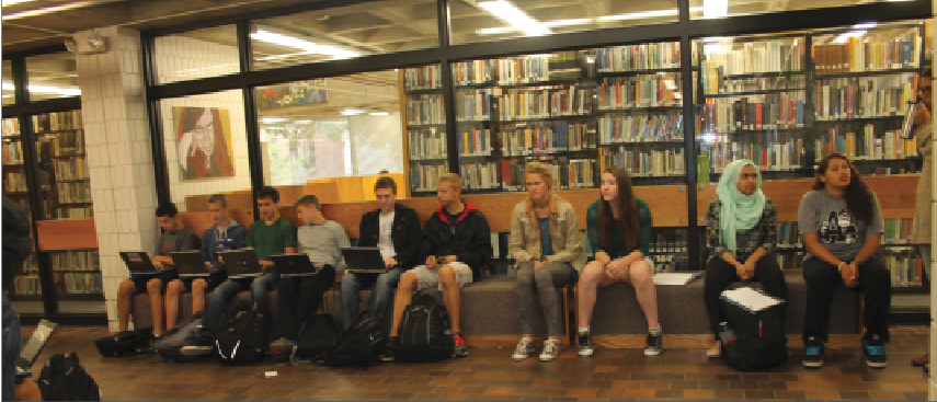 Members of the Class of 2015 line the junior benches on the first floor.  “If I need to find a junior or sophomore, I have a good chance of finding them [at the benches],” Upper School history teacher Mollie Ward said.