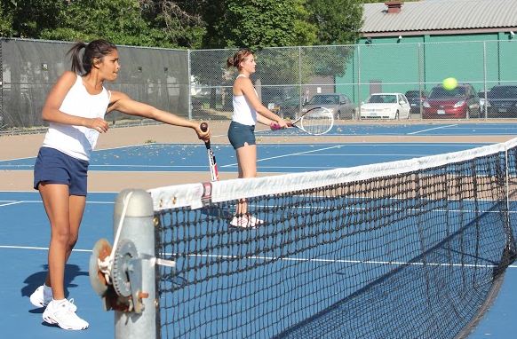 Senior Aria Bryan and junior Eva Zaydman practice hitting volleys. “I know we have a lot of talent on the team,” Bryan said.