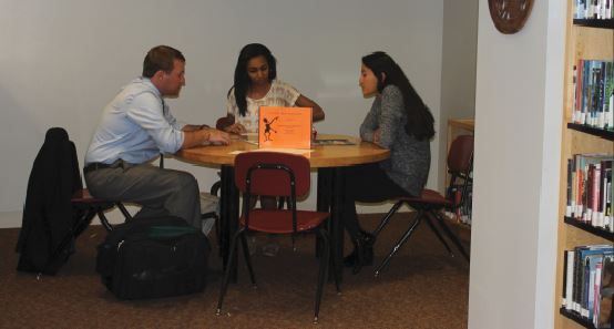 Junior Mansuda Arora and Senior Emma Chang meet with a college representative. “The process can seem really stressful and really hard but it doesn’t have to be,” Assistant Director of College Counseling Karna Humphrey said. 