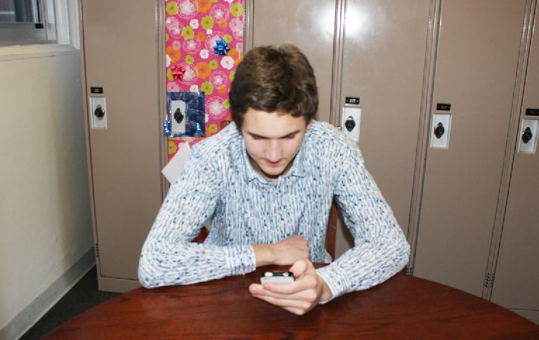 Senior Connor Allen plays Candy Crush Saga on his phone. “It is really fun and addicting, he said. 