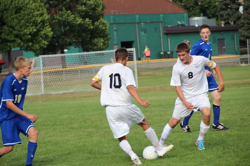 Senior Mason Mohring and junior Tyler Seplak play during a game against Academy of Holy Angels on Sept. 10. “It was hard at the beginning to get team unity but we’re all working hard for each other. Everyone really respects each other,” midfielder junior Jordan Hughes said. 