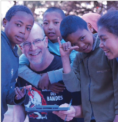 Former Upper School math teacher George Leiter measures a group of Malagasy children for new TOMS© shoes on Sept. 26. “I’d heard of TOMS ® shoes before,” Leiter said. “But it’d be easy to say ‘we give away shoes,’ and never actually get around to it. It’s nice to know they’re really giving shoes away.”