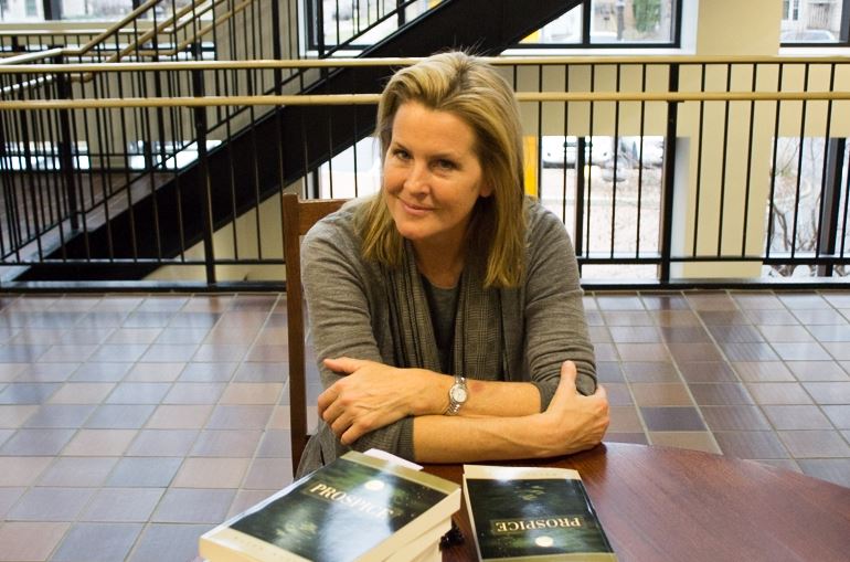 Author Karen Kelley sits at her book signing table on Nov. 21. "I started to write because I needed a creative outlet," she said.