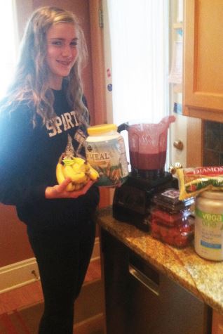 Freshman Moira McCarthy prepares to make a smoothie. “I usually for school make a smoothie with fruit and sometimes kale or beets because you can’t taste it,” she said.
