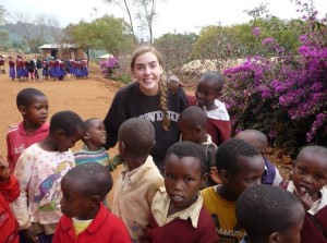 Senior Claire Foussard poses for a picture with locals from her Tanzania trip.
