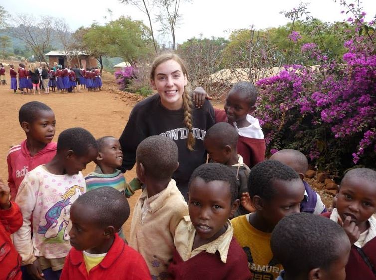 Senior Claire Foussard poses for a picture with locals from her Tanzania trip.