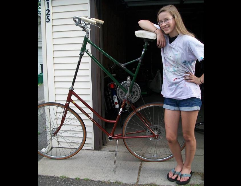 Senior Kaia Findlay poses next to the tall bike she built herself with help from her friends at the Grease Pit. “...A lot of people in my neighborhood had them so I thought, I want one of those,” she said. 