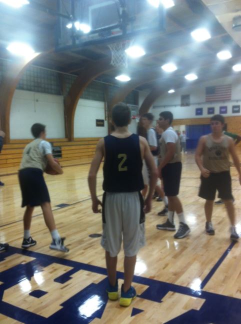 Members of the Boys Varsity Basketball team practice after school, with senior Aidan Arnold on the left, sophomore Ryan Peacock in the middle and junior Louis Bogolub  on the right. Sophomore Dalante Peyton said, “This year will be a different story.”