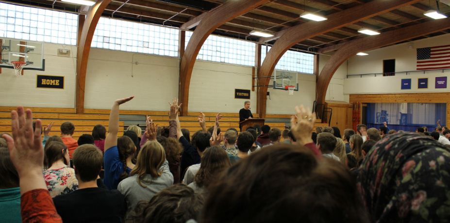 Book Fest keynote speaker John Coy asks questions to the audience during assembly. Fiction, nonfiction, people sitting around talking--what I love is a good story, he said.