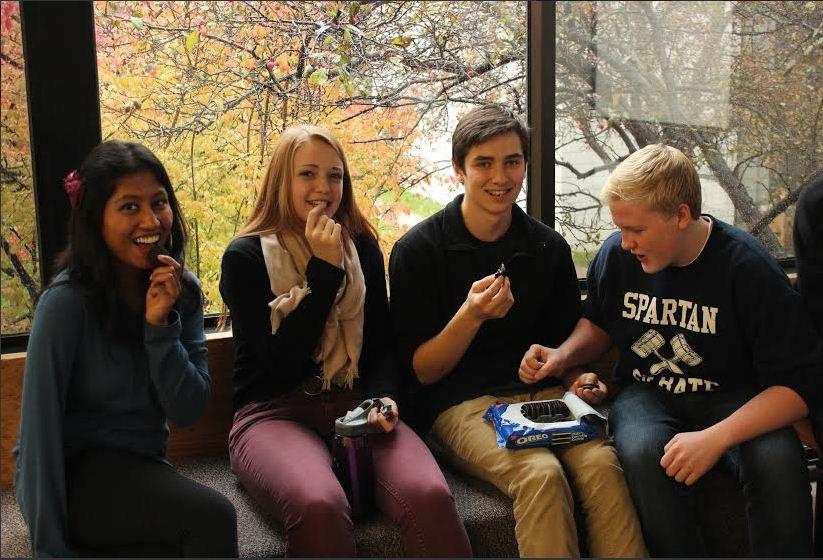 Sophomores Navodhya Samarakoon, Lexi Bottern, Lukas Kelsey-Friedemann, and Brendan McGlincey enjoy a box of Oreos. Many students enjoy Oreos; however, the snack causes some students disappointment because Oreos are brought to often to student meetings. “I’ll get sick of Oreos really quick,” sophomore Alena Porter said.