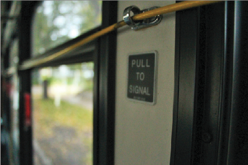 To signal the bus driver that their stop is approaching, riders must pull a yellow cord. 