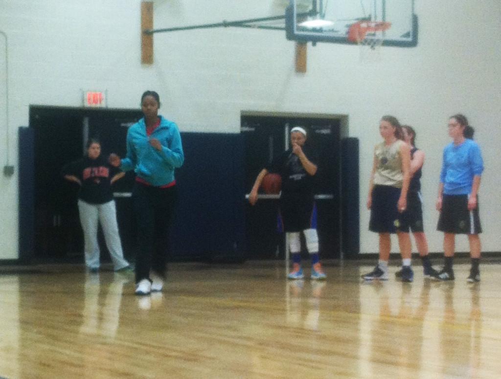 Womens National Basketball Association player Tayler Hill works with guards on how to improve their shot fakes and jab steps. “We could be her one day; it all starts with the first game,” junior Jeline Claiborne said. 