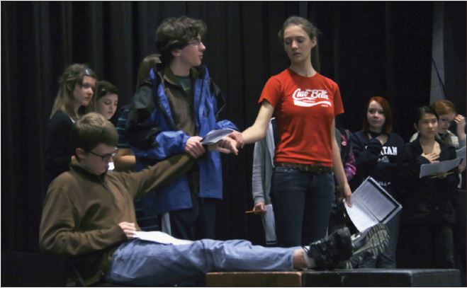 Freshman Cole Thompson, junior Halsey Moe (sitting) and senior Charlotte Hughes rehearse a wedding scene from The Caucasion Chalk Circle. “The cast has been absolutely
phenomenal,“ Upper School theater director Eric Severson said.