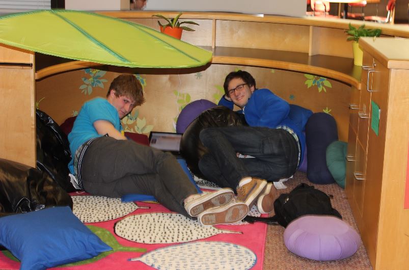 Seniors Jonathan Sogin and Connor Allen relax in the library. “I think what we’re really missing now is a chimpanzee,” Allen suggested. “If we could just have a chimpanzee to cuddle with, that would be prime.” 