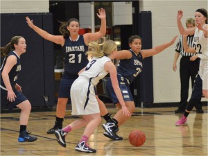 From left: junior Sarah Romans, junior Katie Ademite and senior Jonte Claiborne defend the ball in their Dec. 3 game against St. Croix Preparatory Academy. The team won 66-44.