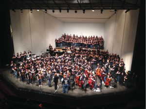 Students stand for applause at the end of the Pops Concert on Dec. 7, 2013. “In general, I am very happy with all of my students this year. Everyone is working hard and is doing their very best,” Upper School Orchestra Director Englehardt said.
