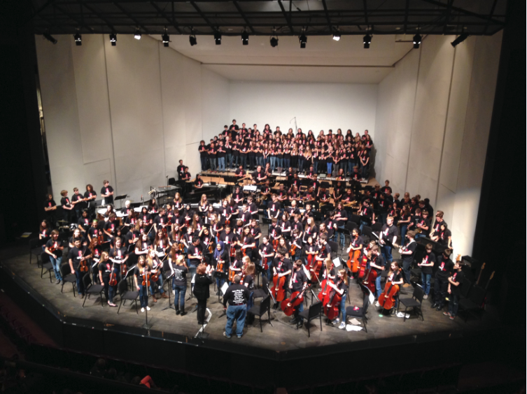 Students stand for applause at the end of the Pops Concert on Dec. 7, 2013. “In general, I am very happy with all of my students this year. Everyone is working hard and is doing their very best,”  Upper School Orchestra Director Englehardt said. 
