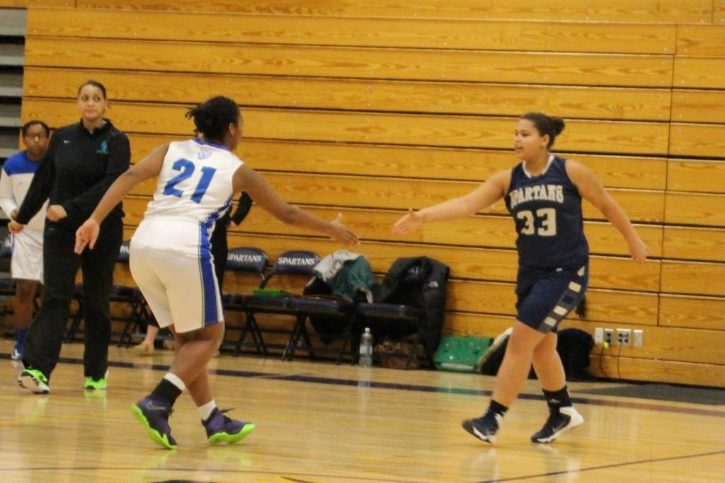 Senior Girls’ Basketball captain Jonte Claiborne shakes hands with an opponent of Blake prior to the team’s Jan. 30 game. “Nobody wants to lose a conference game-- especially to someone who is as big of a rival as Blake is to us,” junior basketball player  Katie Ademite said.