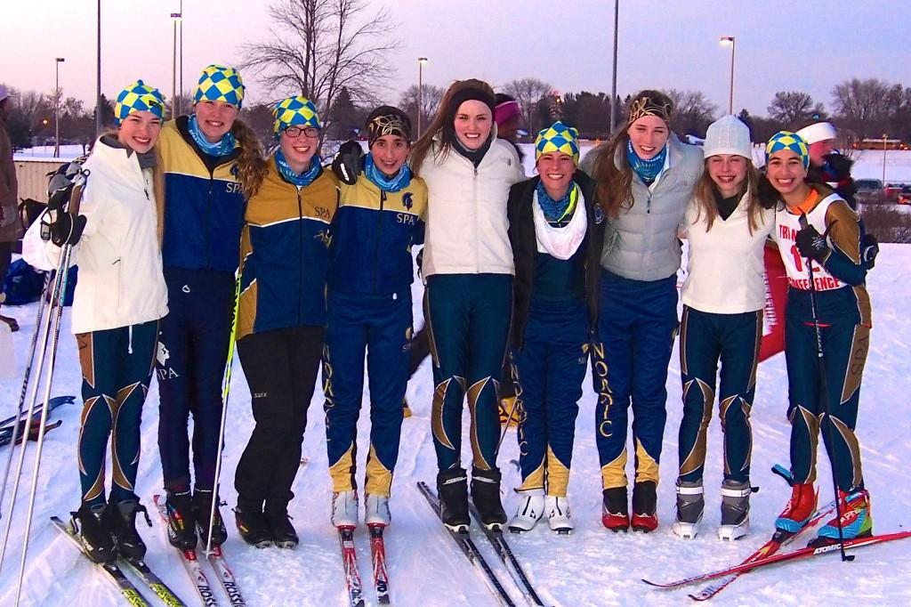 Junior Ellen McCarthy with the Spartan Nordic Ski Team at the Jan. 9 conference meet at Battle Creek.  From left: sophomore Lexi Hilton, eighth grader Greta Sirek, senior Sela Patterson, eighth grader Dina Moradian, senior Katrina Hilton, eighth grader Val Hart, junior Ellen McCarthy, junior Mary Naas, and freshman Neeti Kulkarni. “... the SPA team has allowed me to become a leader,” McCarthy said. 