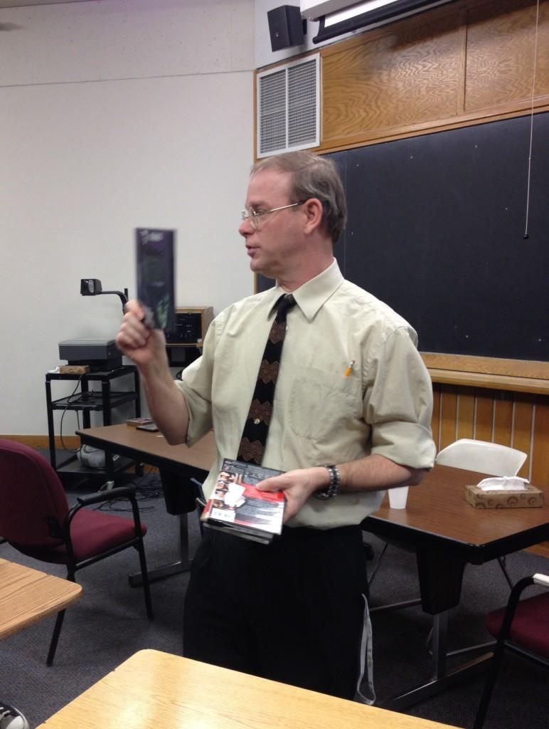 Faculty advisor of Film Club Randall Findlay prepares to draw names from a bowl to determine the winners of the raffle. “Kids that stayed for all six movies got a shot at winning prizes,” senior Film Club president Christian Koch said. 