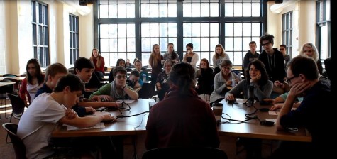 Quiz Bowl members and faculty go head-to-head as they face difficult academic questions, surrounded by an audience of other students and teachers. 