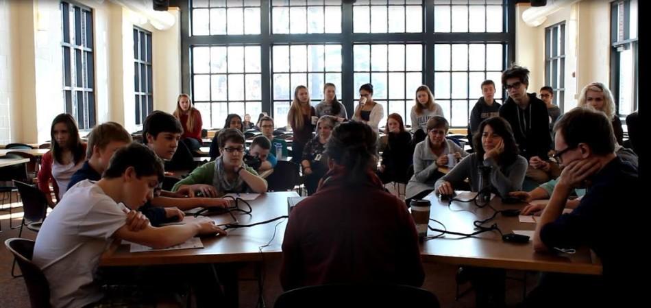 Quiz Bowl members and faculty go head-to-head as they face difficult academic questions, surrounded by an audience of other students and teachers.