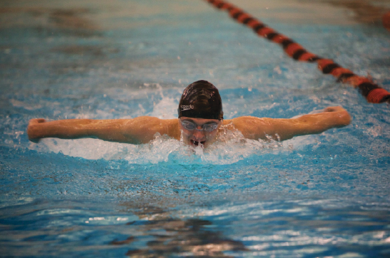 Sophomore Karsten Runquist does the butterfly stroke at the Jan. 24 meet at Humboldt. “... we all got into the locker room and start screaming as loud as we could to get pumped up,” freshman Matt Suzuki said.