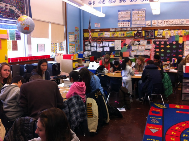 Upper School students color name-tags with their second grade buddies on Service Day at the Community School of Excellence in St.Paul. 