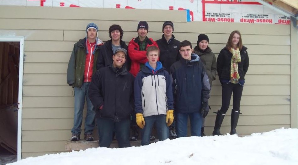 From top left to bottom right, senior Chris Pifer, senior Vittorio Orlandi, senior Philip Swanson, senior Charlie Southwick, junior Amber Skarjune, senior Sam Carlson, junior Carrie Jaeger, junior Kevin Patterson, and junior Thomas Toghramadjian pose for a picture after a hard day of work at one of Habitat for Humanity’s St. Paul homes.