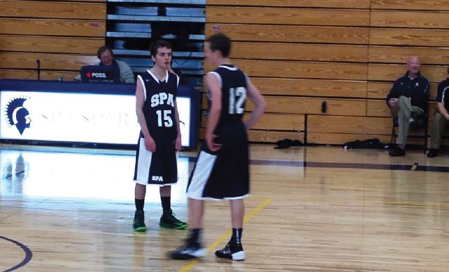 From left: junior Jack Labovitz and sophomore Charley Hooley converse during the JV Boys Basketball game against Duluth Marshall Nov. 23 at Briggs gymnasium. SPA went on to beat Duluth Marshall 59-24 for their first win of the season.