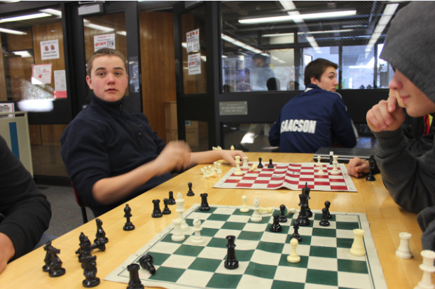 Parallel chess games go on in the lower library, with junior Kit Rasmussen at one board and junior Jack Labovitz at the other.  “I enjoy the stimulating intellectual competition. How it’s so challenging,” Rasmussen said.