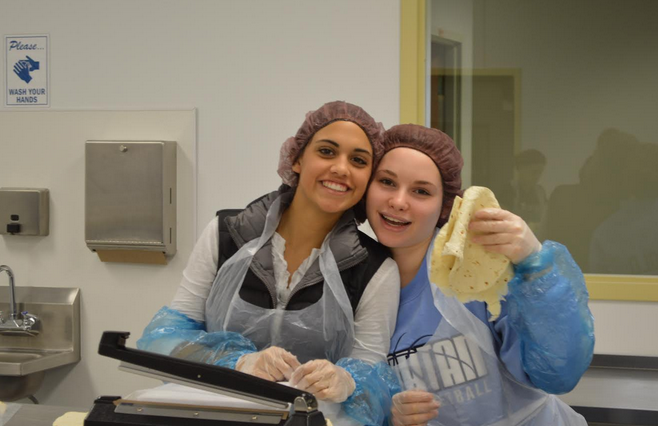 Sophomores Sami Brattland and Minnie Arnold make tortillas. 