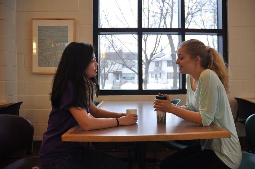 What would one see around St. Paul Academy and Summit School during the school day? Tea in hand, senior Jessica Wen chats with visitor Lotta Bublitz in the lunch room. 