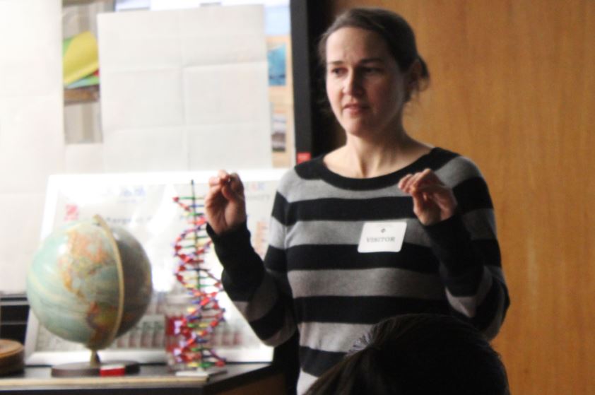 Researcher Andrea Bailey demonstrates the difference between humans and other primates by showing that humans have dexterous fingers. 