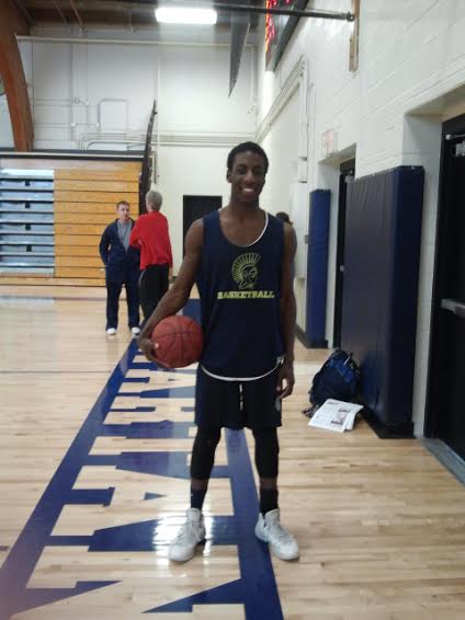 Sophomore Dalante Peyton poses with a basketball on the court. It is so nice to be a part of a team sport, he said.