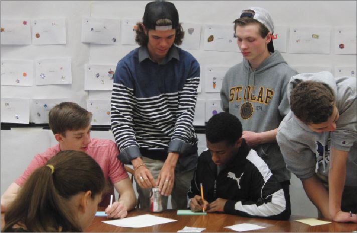 From left: seniors Ann Hill, Josh Johnson, Dylan White, Emun Solomon, Lowell Naas, and Bryant Carlson write notes during their retreat on April 2. “ A large part of the purpose is to... acknowledge where you’ve come from, and acknowledge where you’re going,”  SCLC advisor Eric Severson said. 
