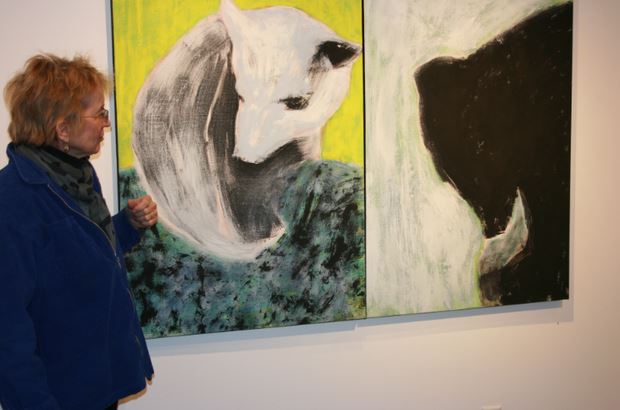 Upper School fine arts teacher Marty Nash stands with one of her pieces in the Harry M. Drake Gallery. "Choosing the literal subject of bears was simply a means to continue my ongoing interest in like forms and the use of gesture within a confined and concentrated space," Nash said. 