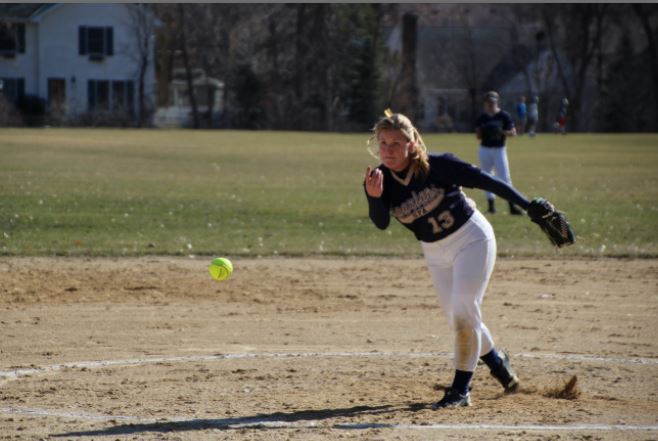 Senior co-captain Alex Miller pitches during the Varsity Softball home game against Highland Park. The team lost 16-18. Im excited and I think were going to be a lot better than last year, Miller said. 