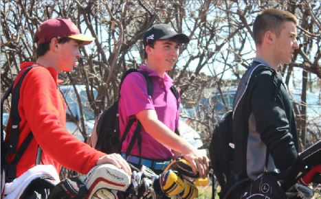 Freshmen Drew and Colin O'Hern and sophomore John Boosalis head off to their golf practice on April 21.